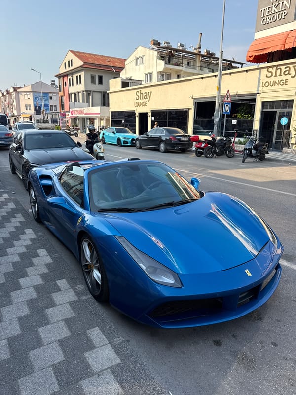 Blue Ferrari convertible parked on a Fethiye street