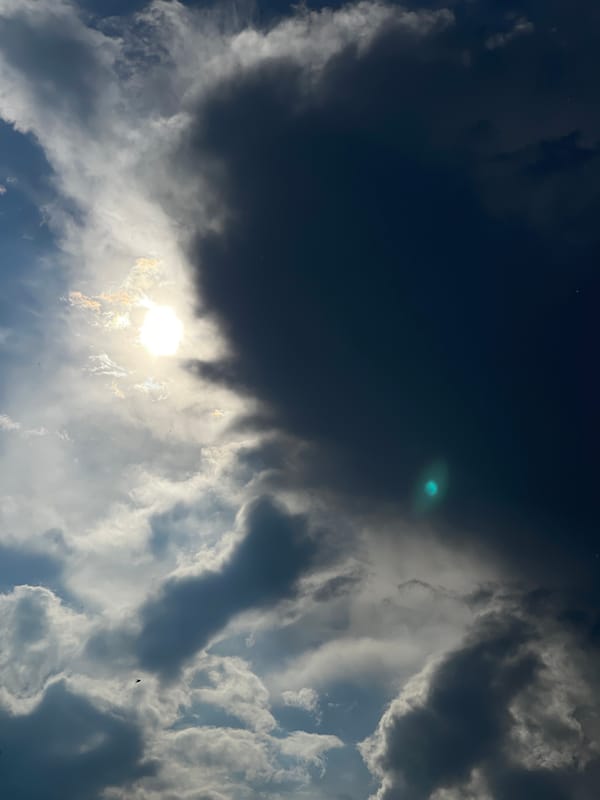 Storm clouds and sunlight create dramatic sky contrast