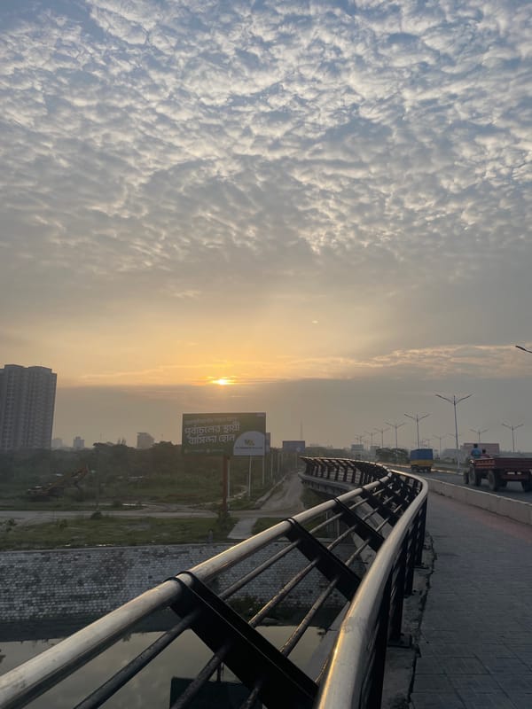 Man in Argentina jersey poses on Dhaka bridge amid urban landscape