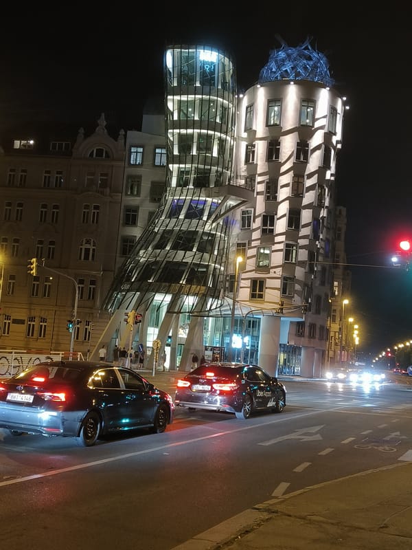 Nighttime Prague scenes captured near Dancing House and canal
