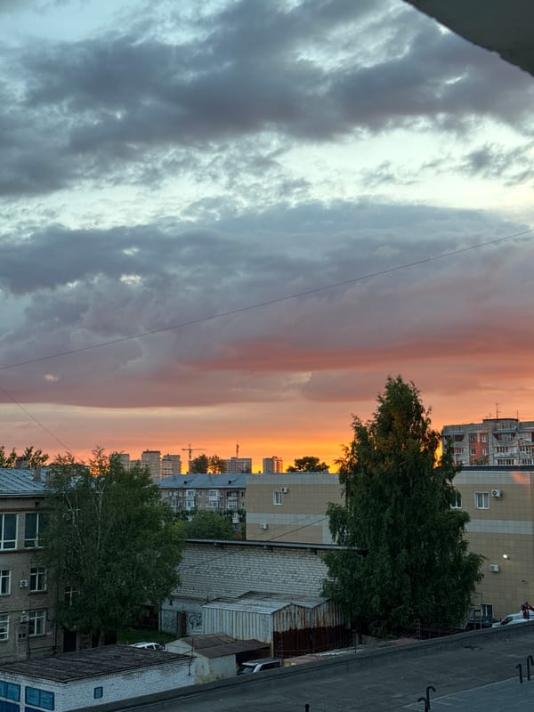 Perm skyline at golden hour, clouds and city silhouettes
