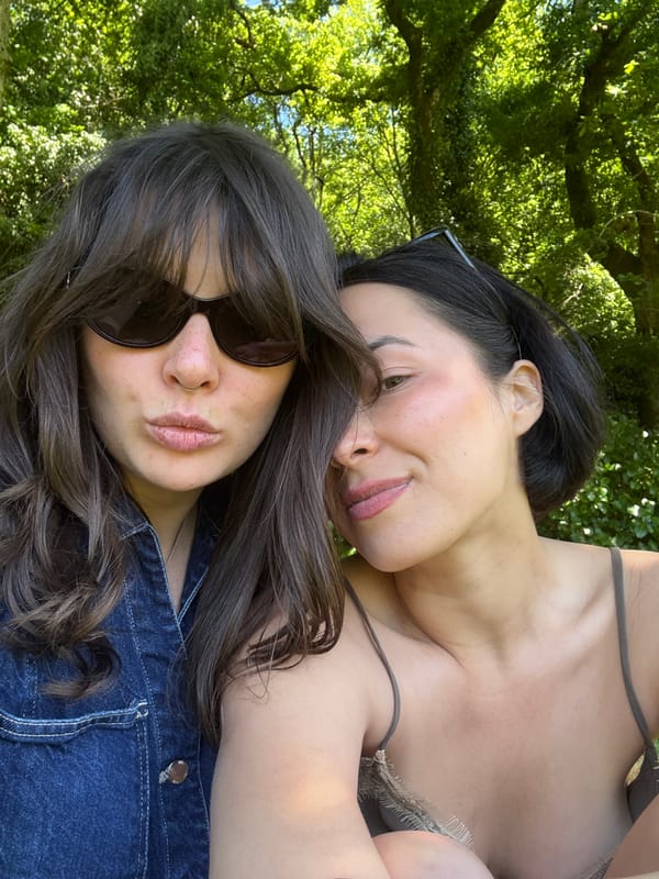 Two women photographed relaxing outdoors in Santiago de Compostela