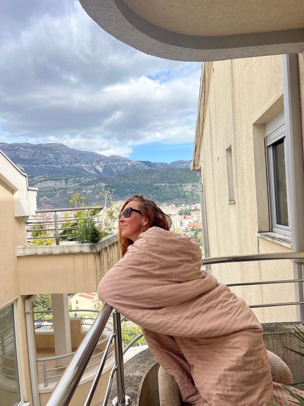 Woman enjoys balcony meal in Budva, Montenegro