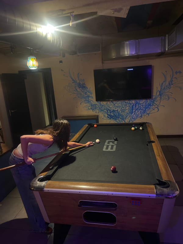 Woman plays pool at Barcelona establishment Friday afternoon