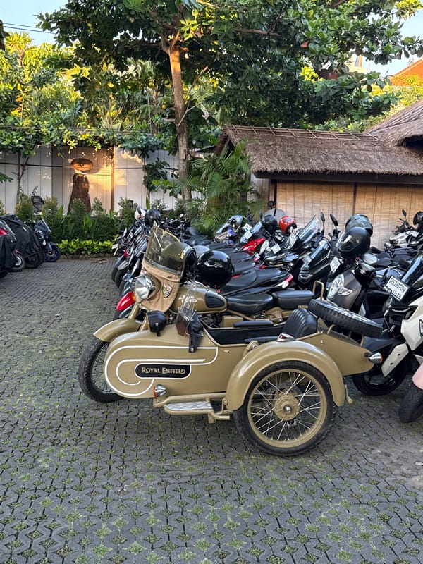 Vehicles parked at Kuta Selatan resort during golden hour