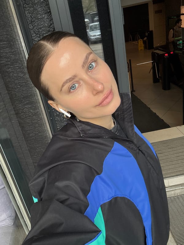 Woman photographed in selfie wearing jacket with earbuds, Krasnoyarsk