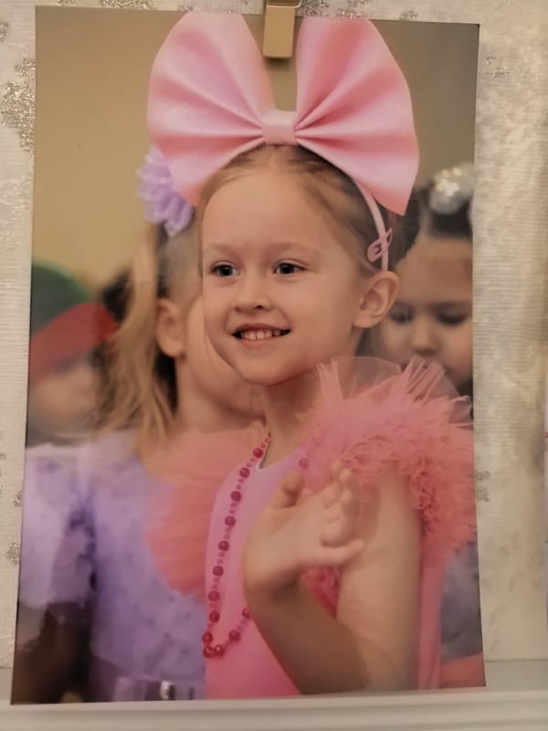 Girl in pink dress waves in Omsk gathering