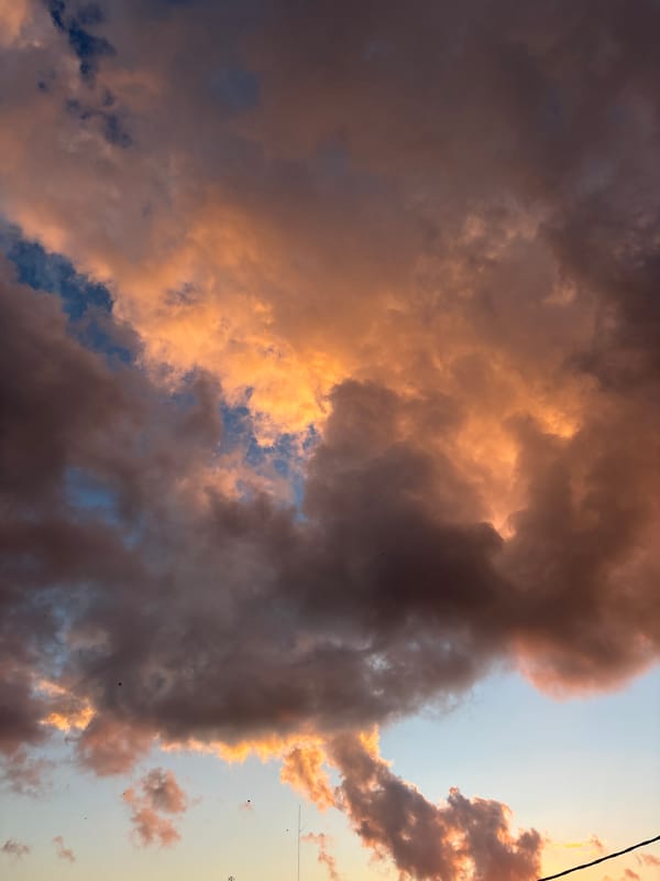 Kuta Selatan sunset, clouds lit up in orange and purple