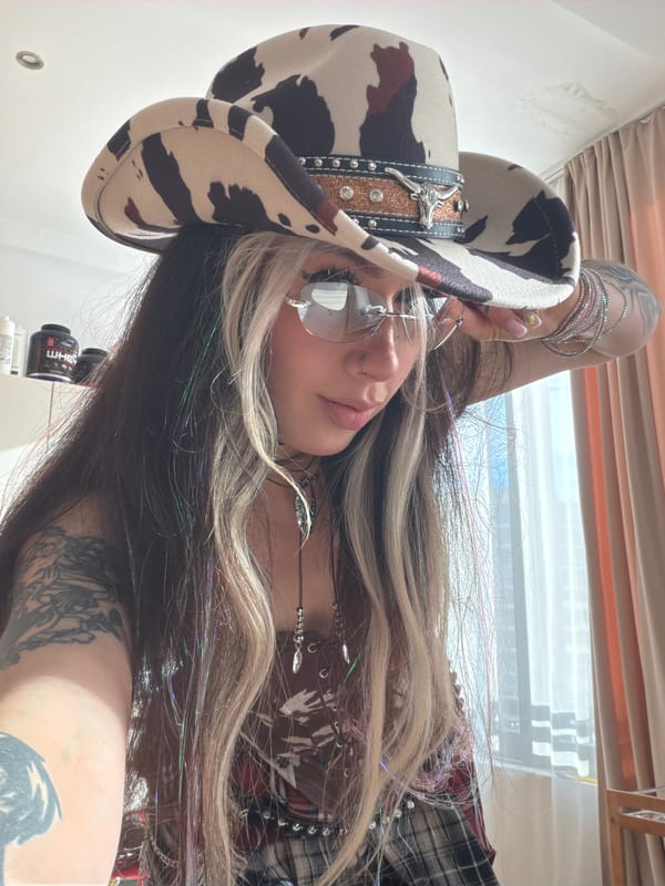 Woman poses in ornate cowboy hat in Budva