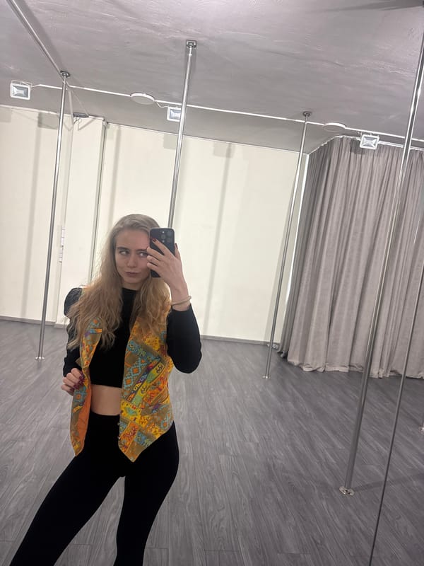 Pole fitness class participants practice routines, take selfies