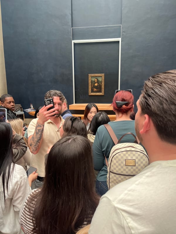Tourists view Mona Lisa at Louvre during midday visit