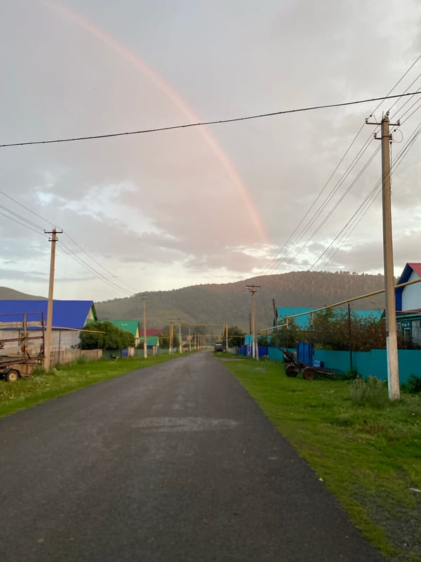 Post-rain summer evening with kids and a rainbow in rural Russia