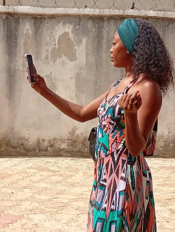 Woman takes smartphone selfies in Rido, Nigeria