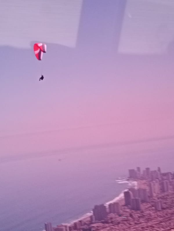 Paraglider soars above Iquique coastline in Chile