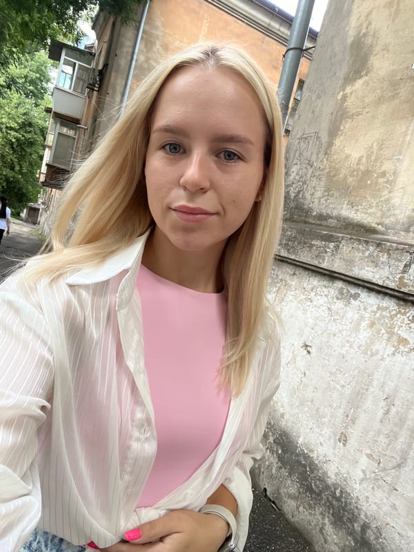 Selfie series in an urban spot, pink top and plaid layers