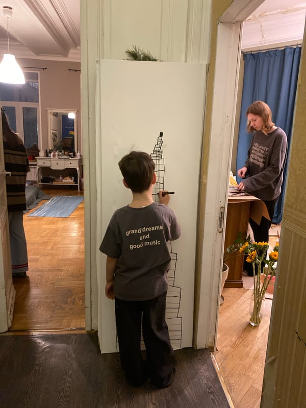 Boy draws on white surface in Moscow
