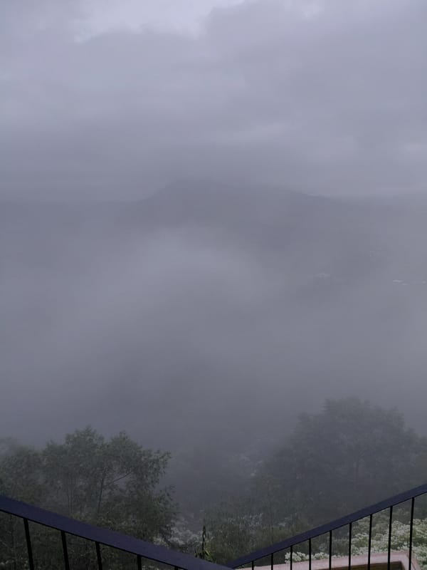 Foggy hillside café stop with rustic interiors and a drone overhead