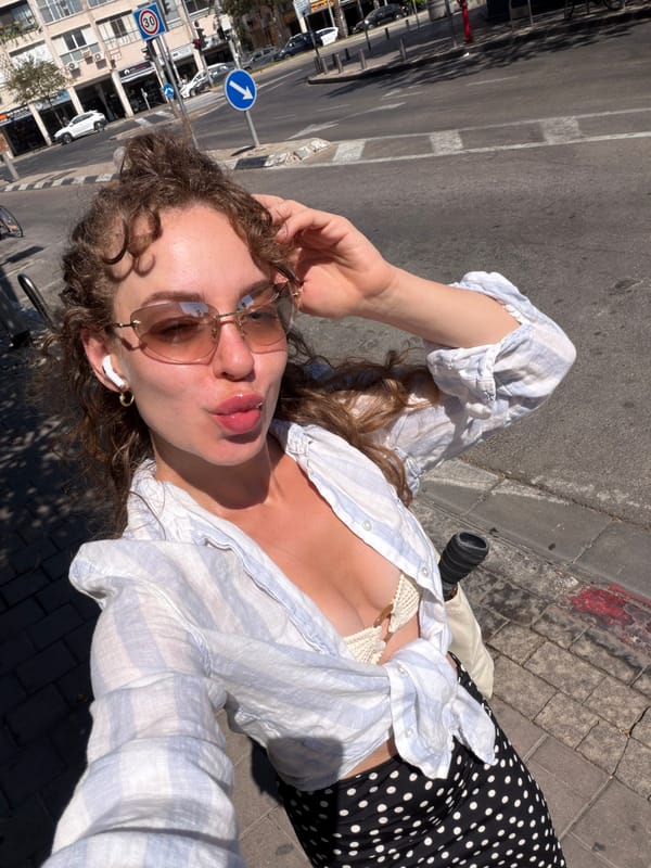 Sunny sidewalk selfies in Tel Aviv, midday.