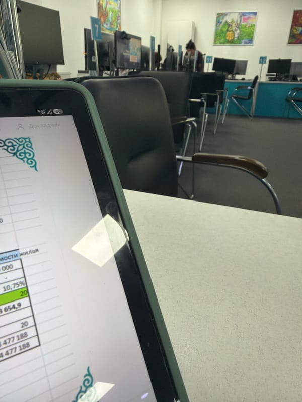 Inside an Astana office: workstations, brochures, and a calculator