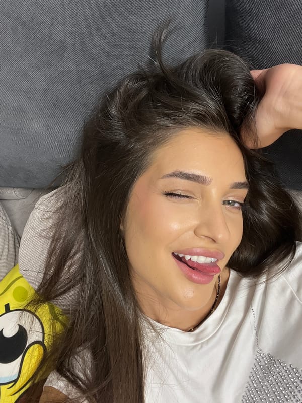 Woman rests on gray couch in Sofia apartment