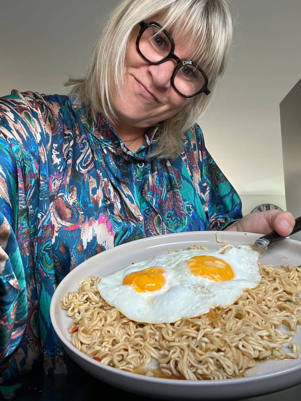 Woman holds noodle breakfast in Chambœuf home