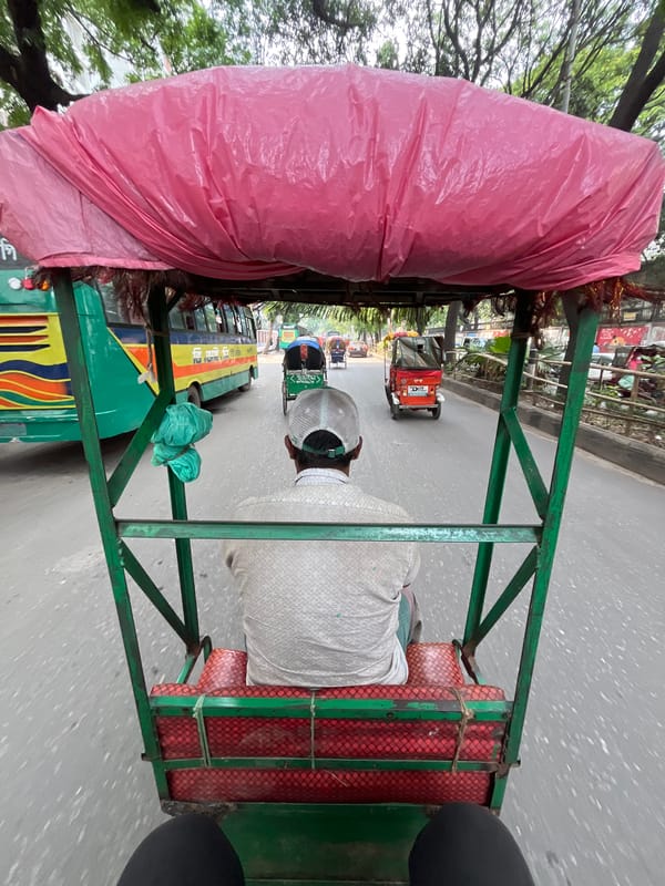 Rickshaw ride captured in Dhaka street scene