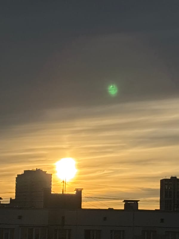 Sunset documented over Russian urban landscape with golden sky