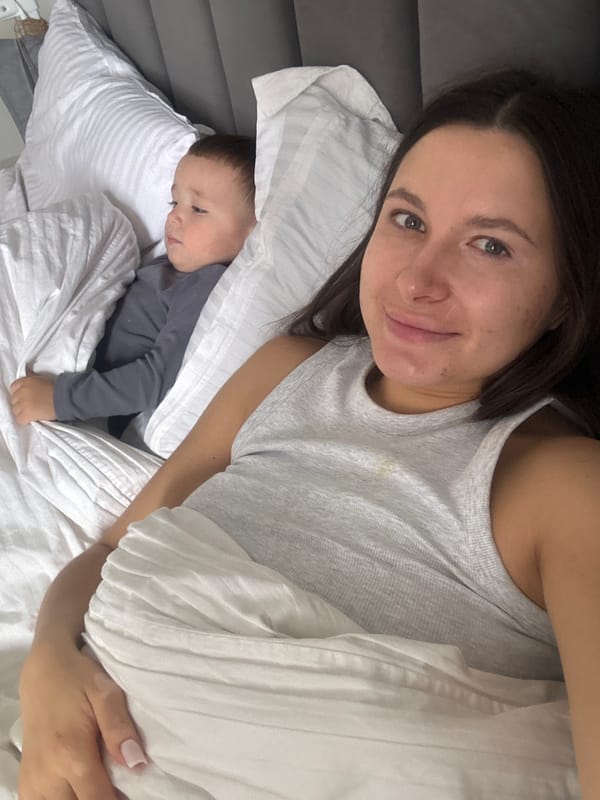 Mother and child share morning moment in Odintsovo bedroom
