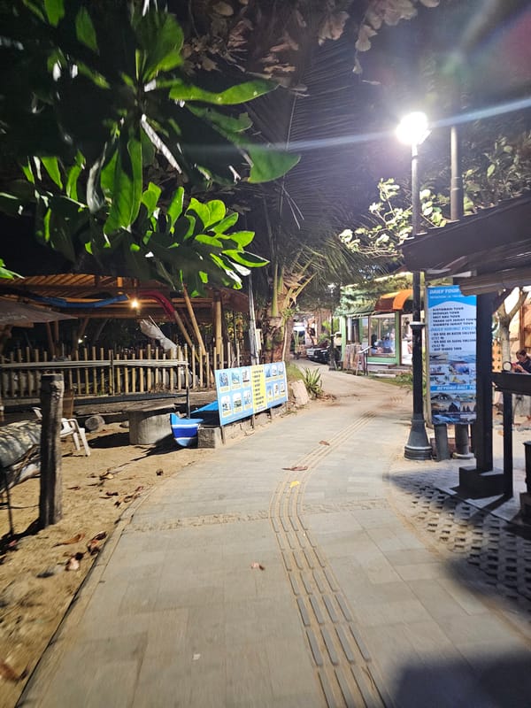 Nighttime scenes around a Denpasar venue strip