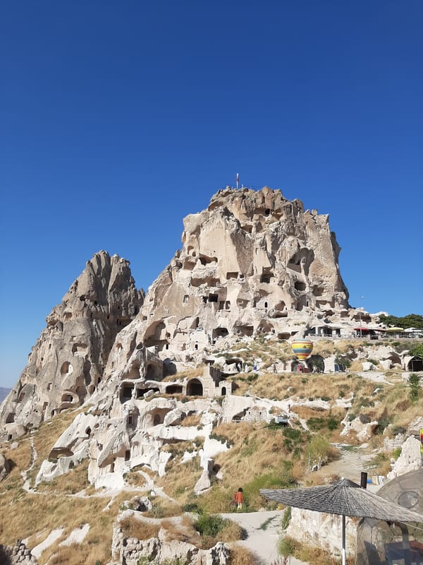 Exploring Uçhisar's cave fortress and Cappadocian landscape.