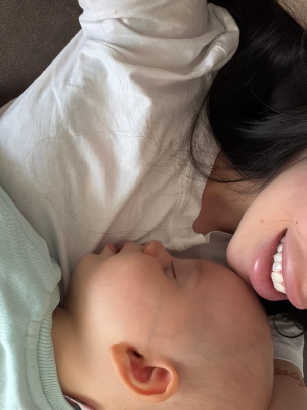 Woman holds sleeping baby in Bulgarian village morning