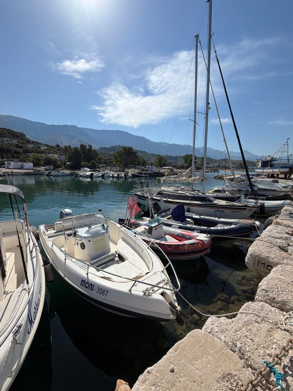 Sunny morning at Orikum's marina and rocky shoreline