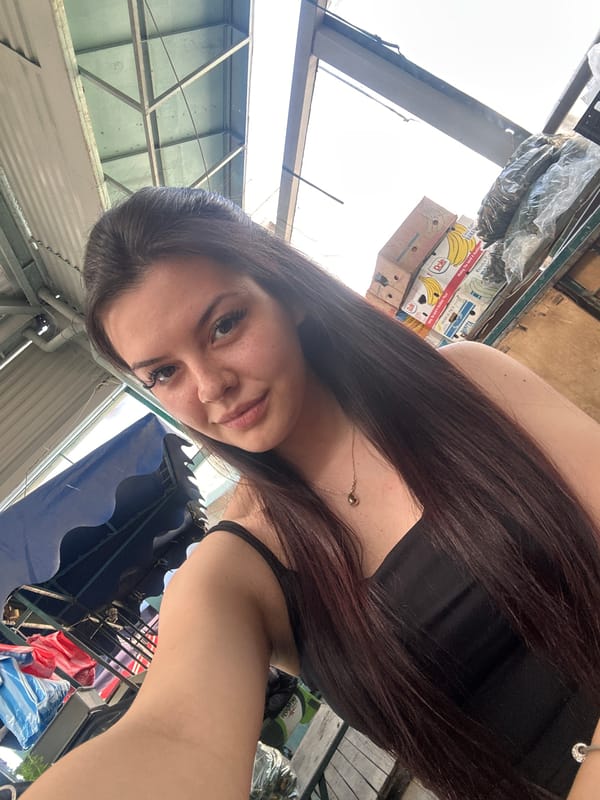 Woman takes selfies at outdoor market in Sliven, Bulgaria