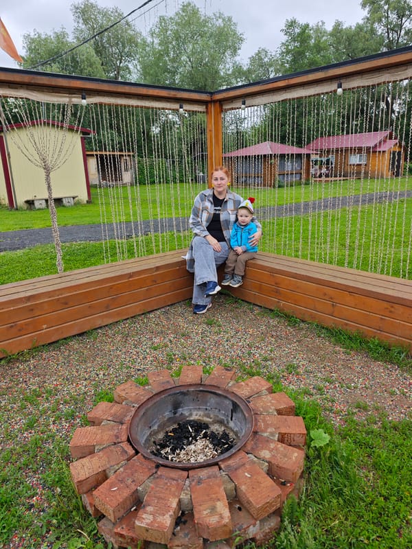 Woman documents peaceful morning at Russian countryside recreational area