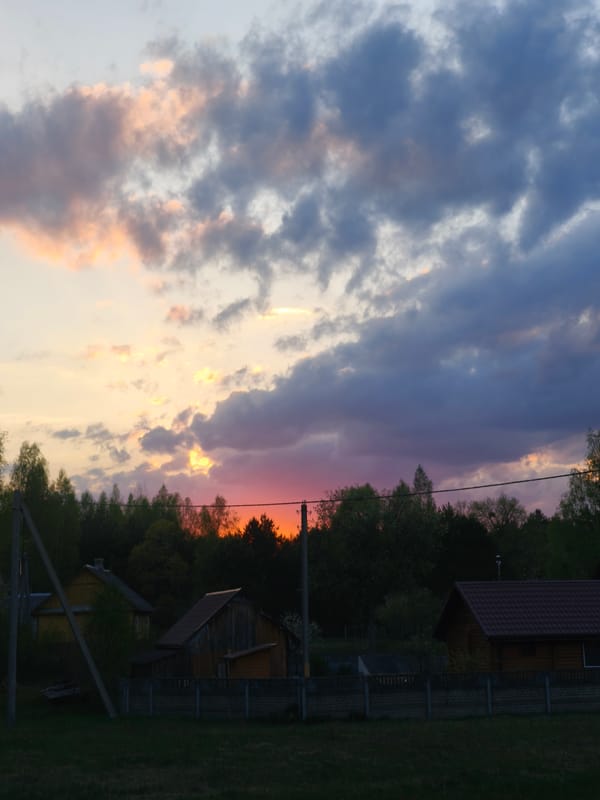 Dusk sky with orange-pink clouds observed in rural Belarus