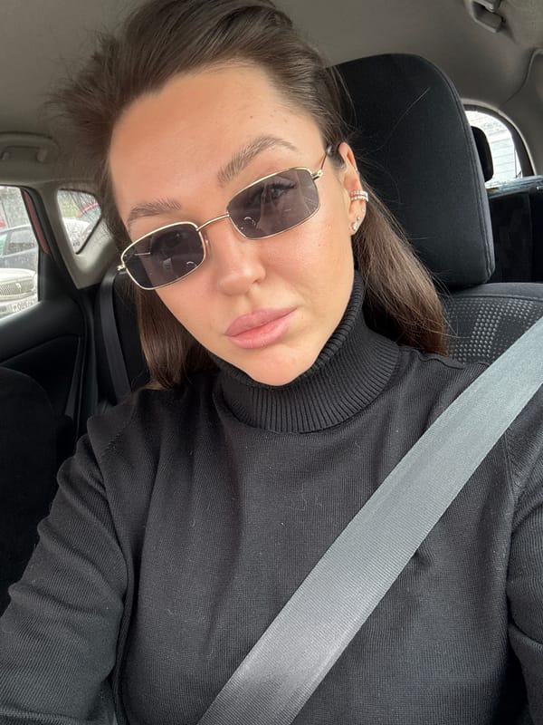 Woman in black turtleneck observed in car, Krasnoyarsk