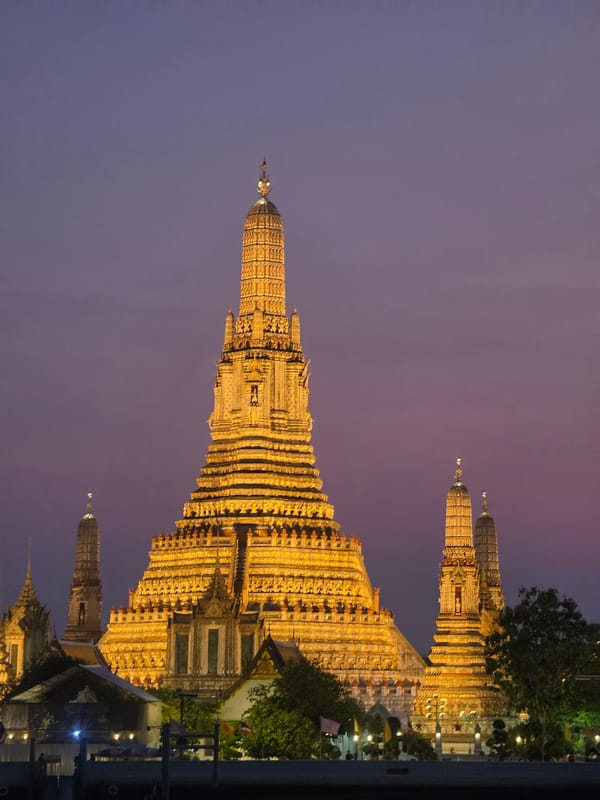 Tourist explores Bangkok's Wat Arun temple district during evening hours