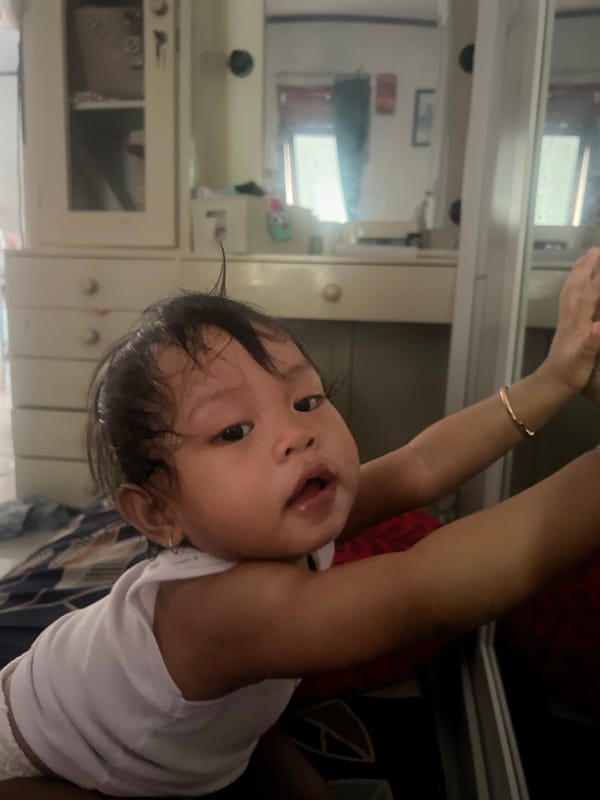 Mother and child share quiet morning moments in Pati home