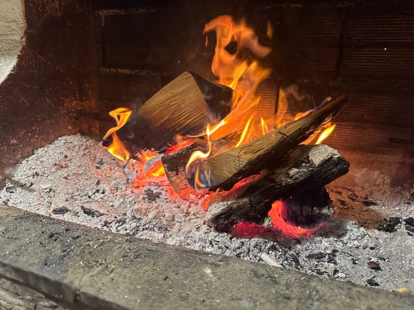 Fireplace burns wood in Γερακινή, Greece home