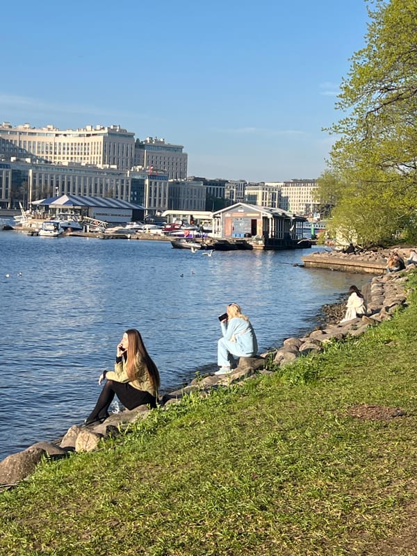 Two people gather at Saint Petersburg waterfront embankment