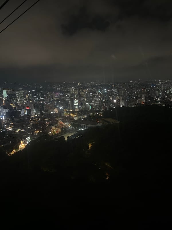 Seoul skyline captured at night with partial cloud cover