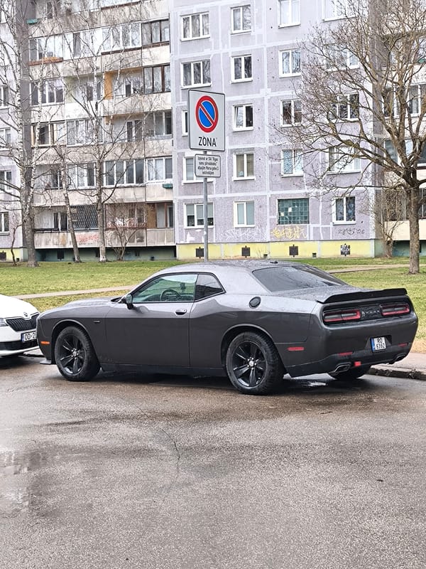 Dodge Challenger spotted on wet Riga street near apartment building
