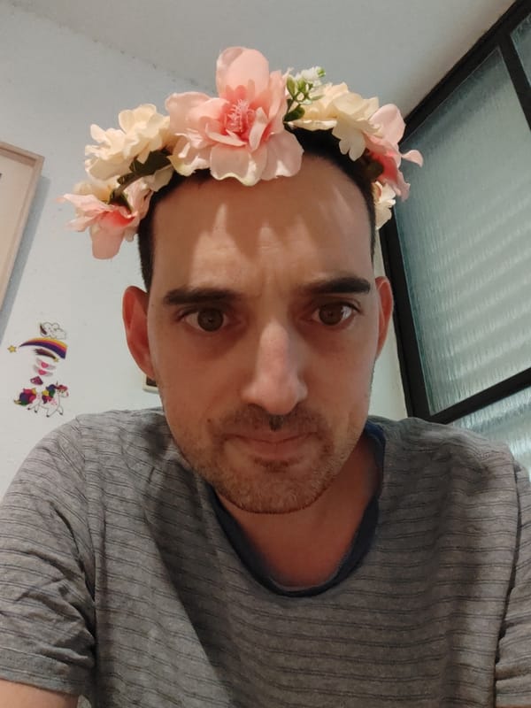 Man poses in flower crown for photo in Tel Aviv