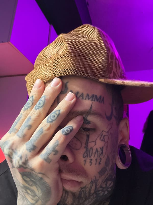 Tattooed individual photographed with black stickers in Buenos Aires