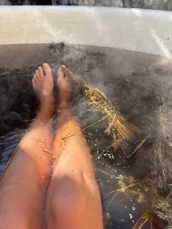 Woman enjoys outdoor herbal hot tub treatment in Russia