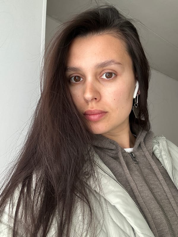 Woman takes selfies with pink phone in Chaikovsky