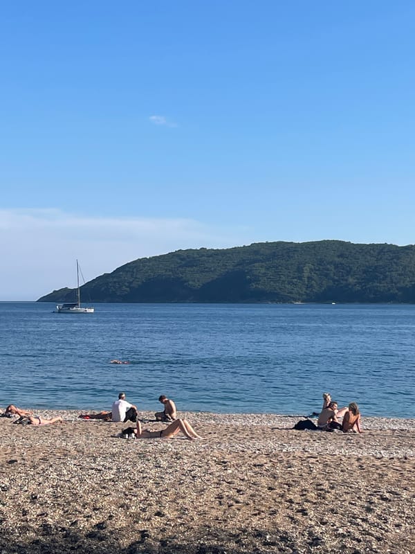 Sunny afternoon beach scene unfolds in Budva, Montenegro