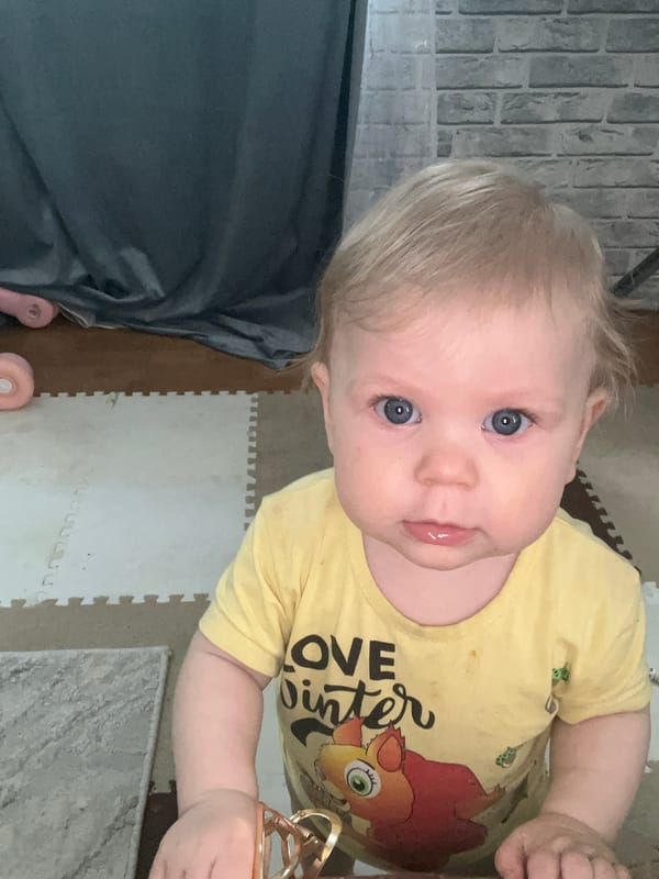 Mother and toddler share quiet indoor moments in Vesyoloye