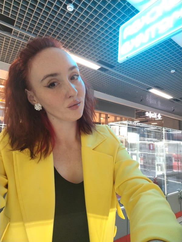 Woman in yellow blazer takes selfies at Izhevsk mall