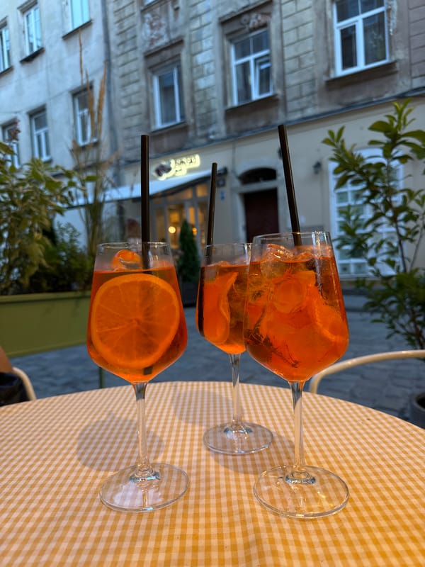 Aperol Spritzes at a cobblestone street café